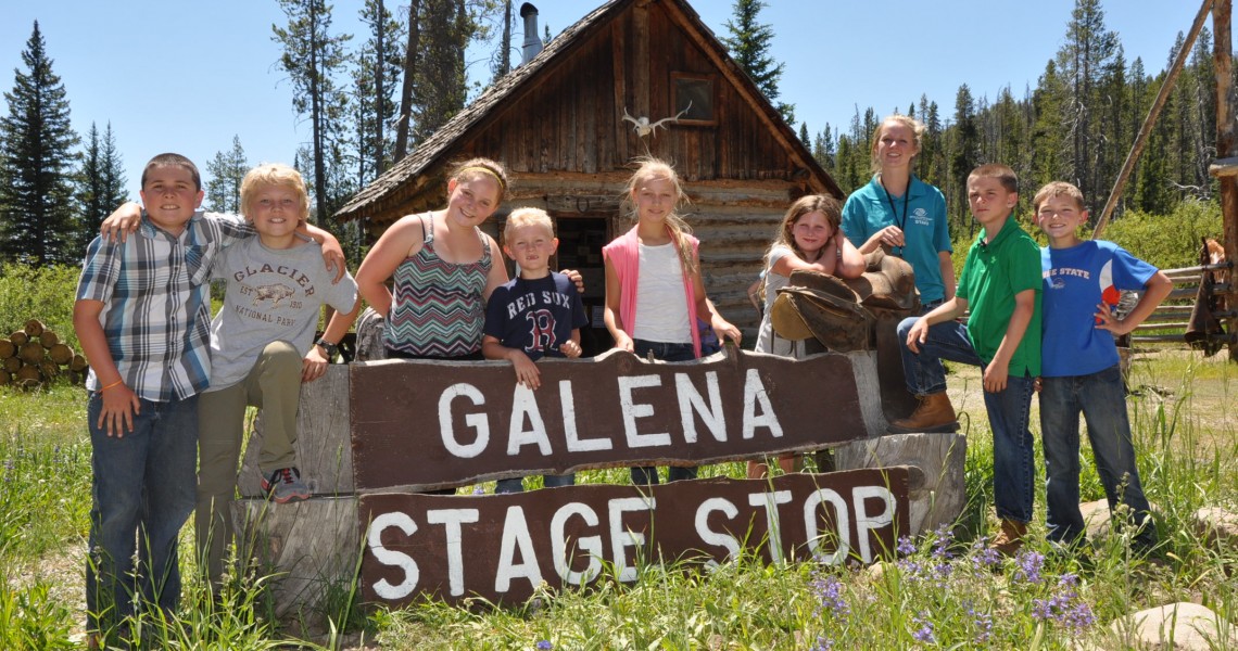 Summer camp group posing by Galena Stage Stop sign.