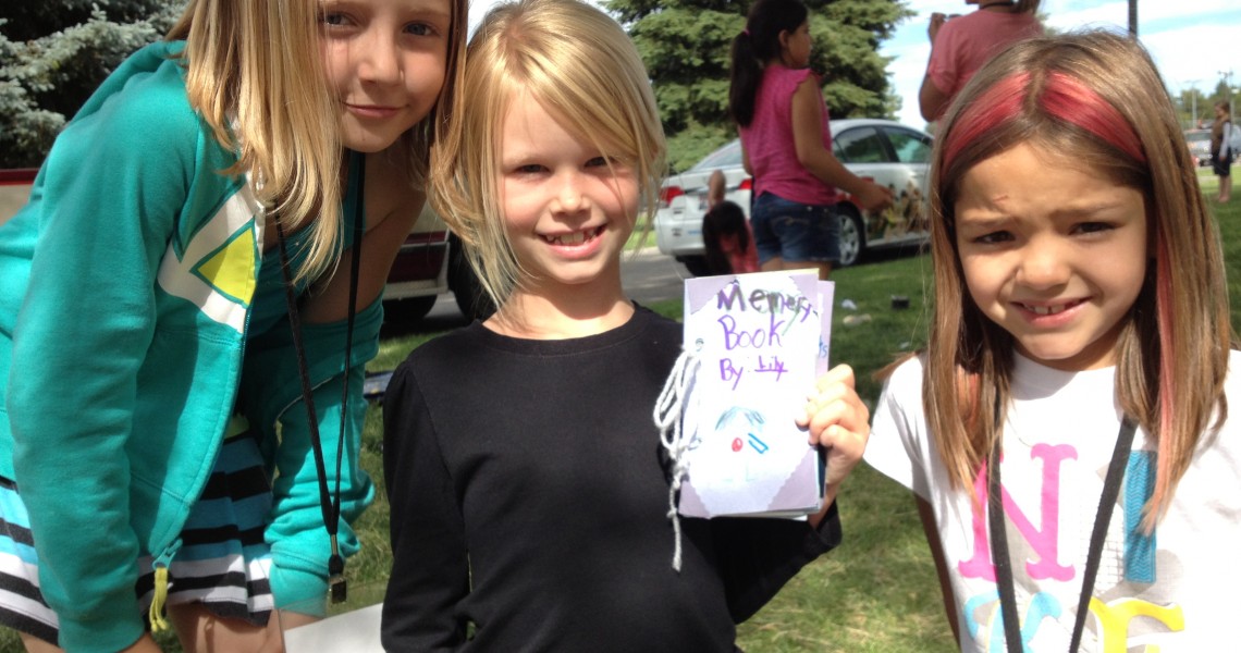 Girls holding memory book during summer activity in Twin Falls, ID.