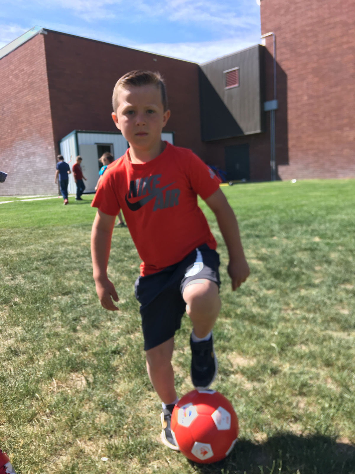 Boy playing soccer in summer camp in Twin Falls, ID.